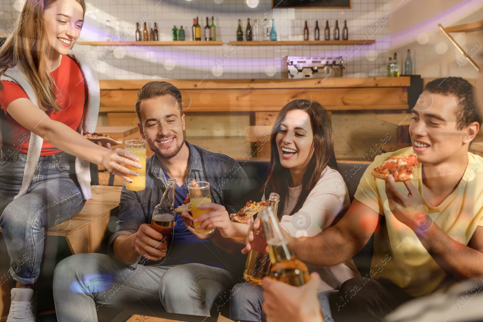 Image of Group of friends having fun party with delicious pizza in cafe, bokeh effect