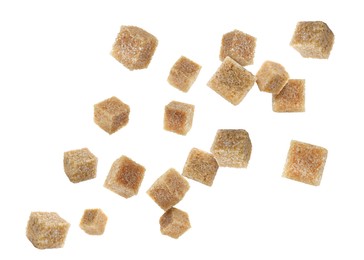 Image of Brown cane sugar cubes falling on white background