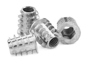 Photo of Metal insert nuts isolated on white. Hardware tool