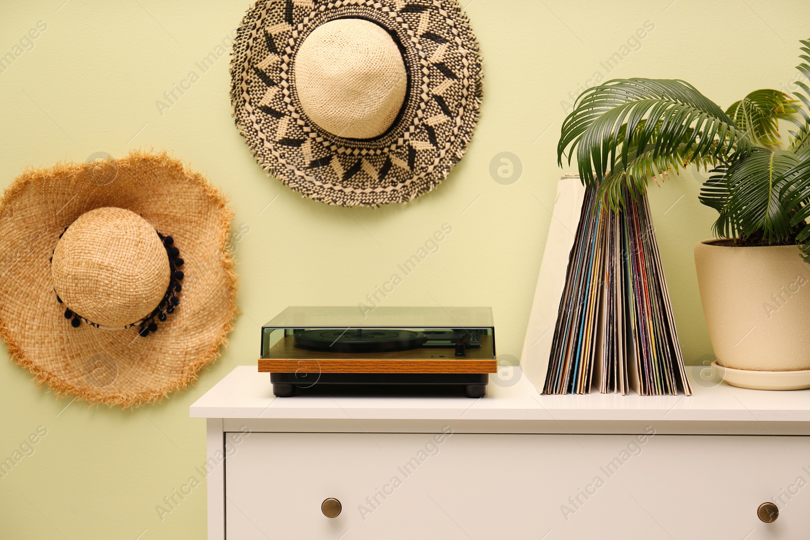 Photo of Stylish room interior with turntable and collection of vinyl records