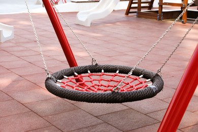 Empty nest swing on outdoor playground in residential area