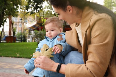 Photo of Happy mother with her son in autumn park