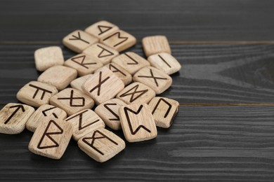 Pile of runes on black wooden table