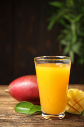 Photo of Fresh delicious mango drink on wooden table