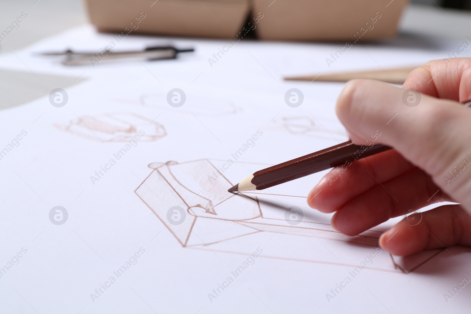 Photo of Woman creating packaging design at table, closeup