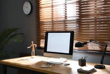 Photo of Modern computer and stationery on wooden table in office