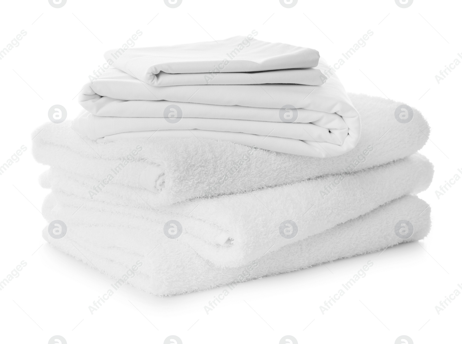 Photo of Stack of towels and bed sheets on white background