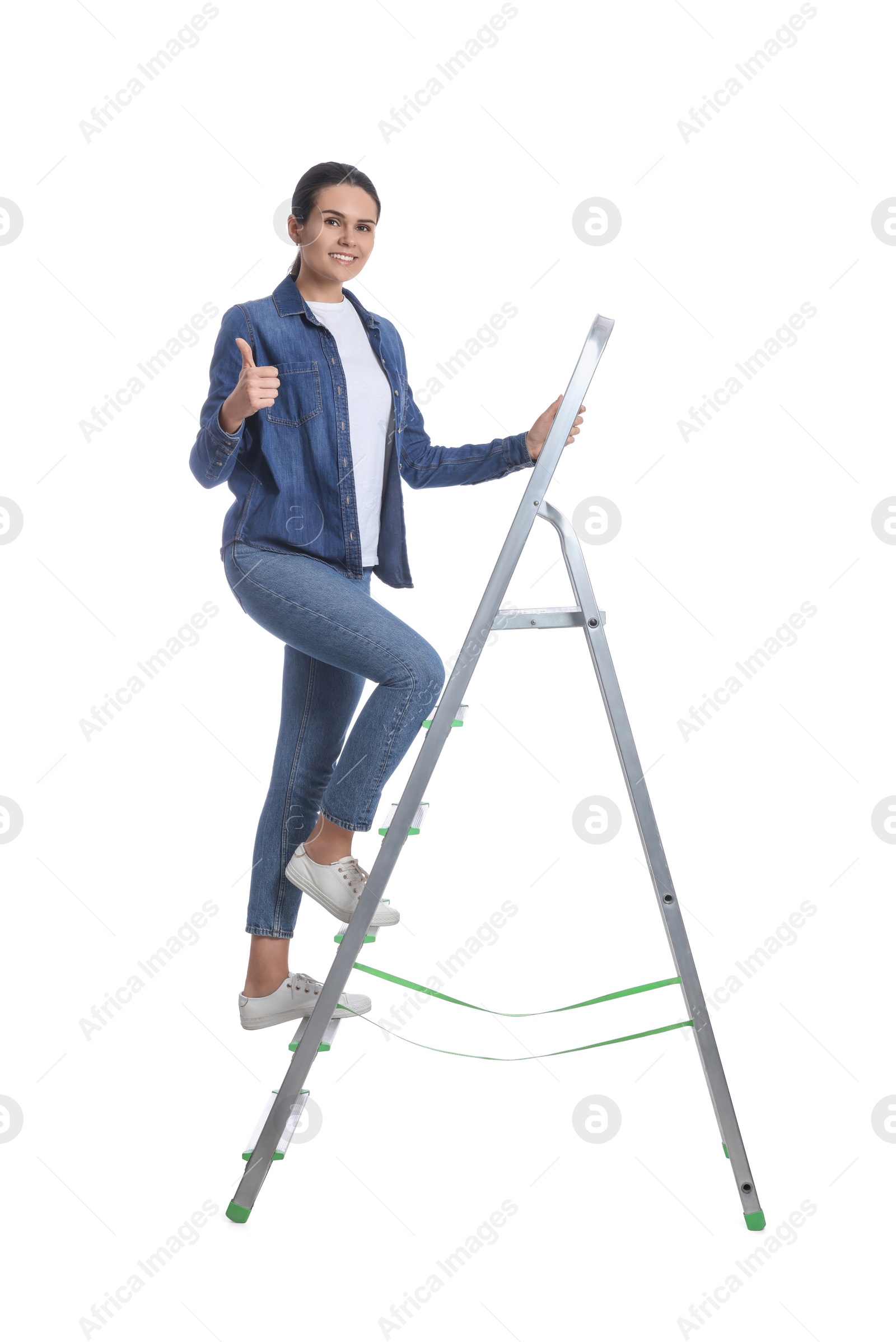 Photo of Young woman climbing up metal ladder on white background