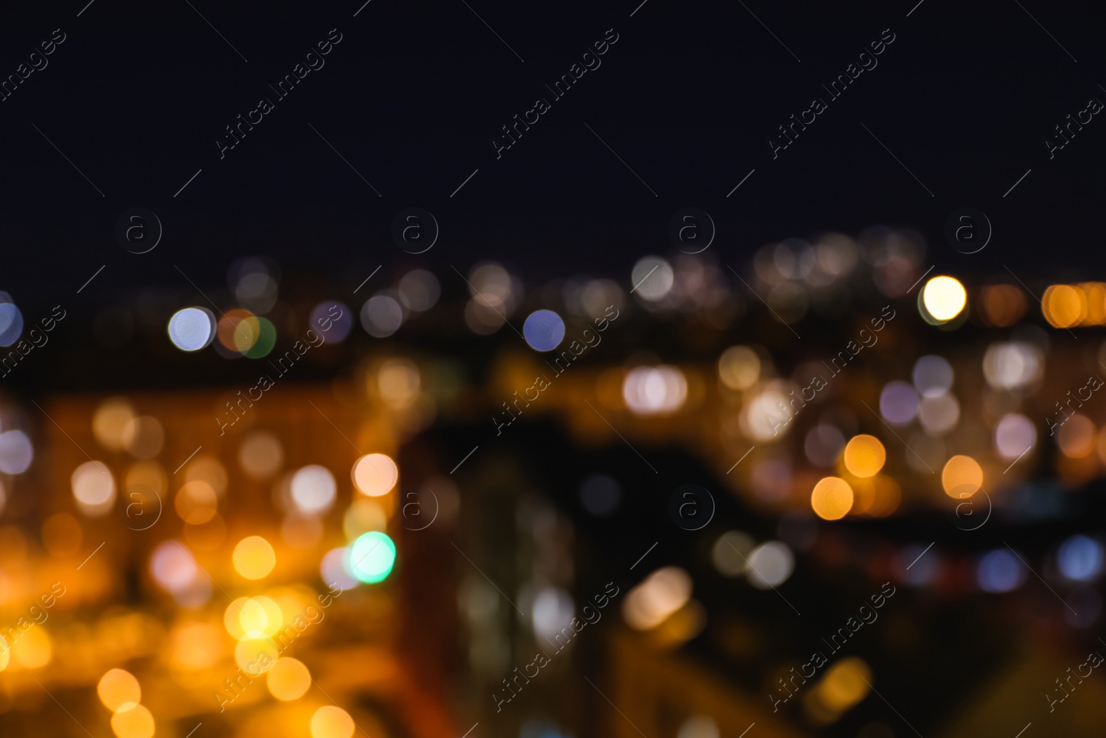 Photo of Blurred view of modern city at night. Bokeh effect