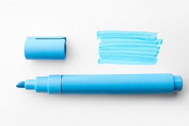 Photo of Different strokes drawn with light blue marker and highlighter on white background, top view