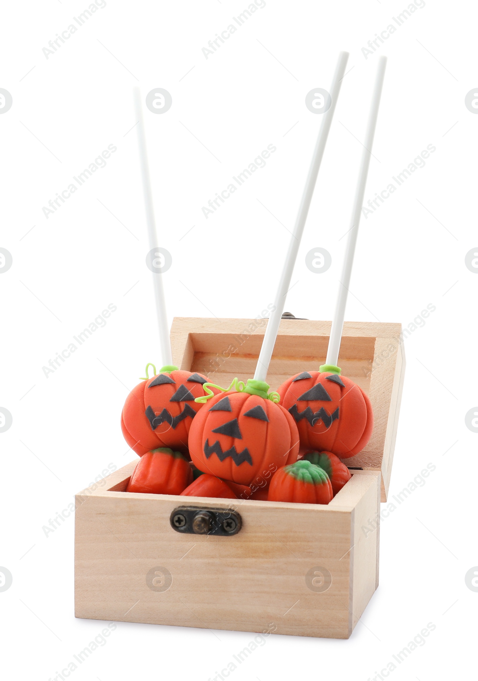 Photo of Delicious jack-o-lantern cake pops in small wooden chest on white background. Halloween season