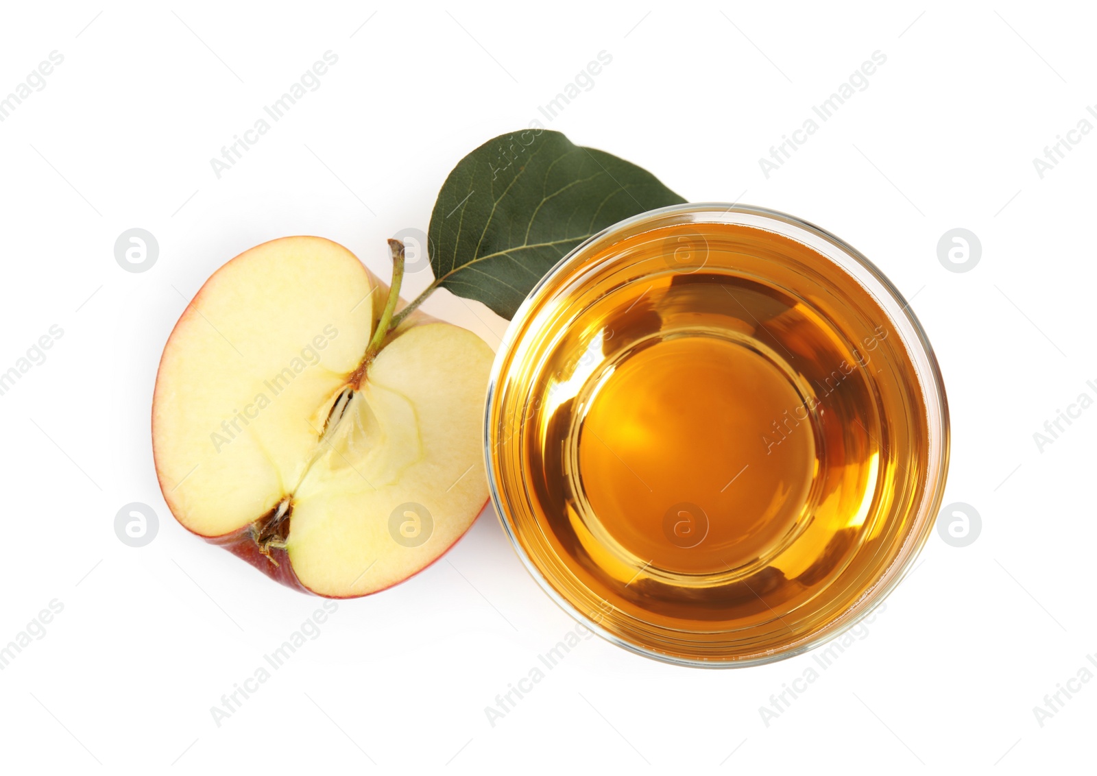 Photo of Glass with delicious cider and piece of ripe apple on white background, top view