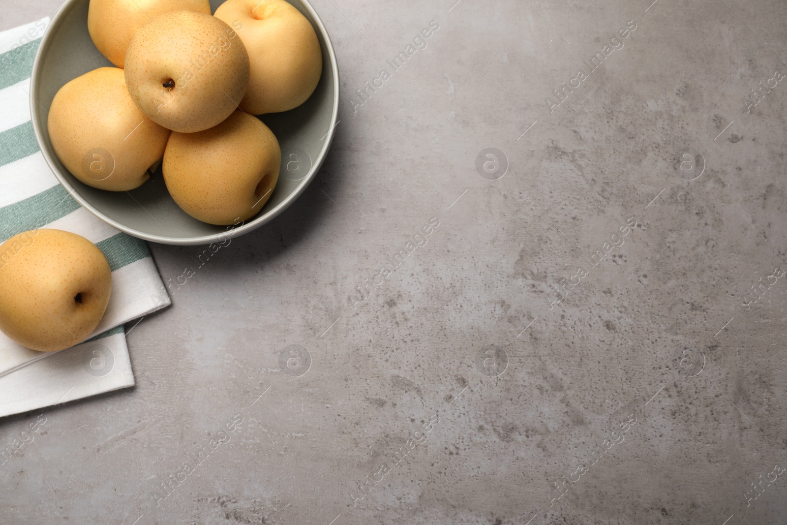 Photo of Fresh apple pears on grey table, flat lay. Space for text