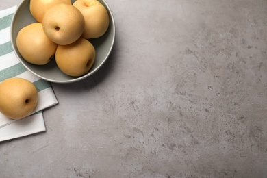 Photo of Fresh apple pears on grey table, flat lay. Space for text