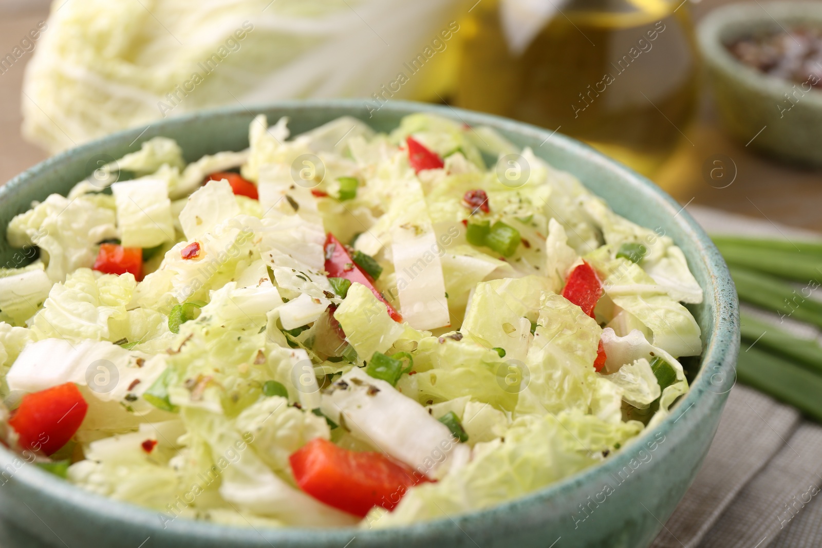 Photo of Tasty salad with Chinese cabbage in bowl on table, closeup