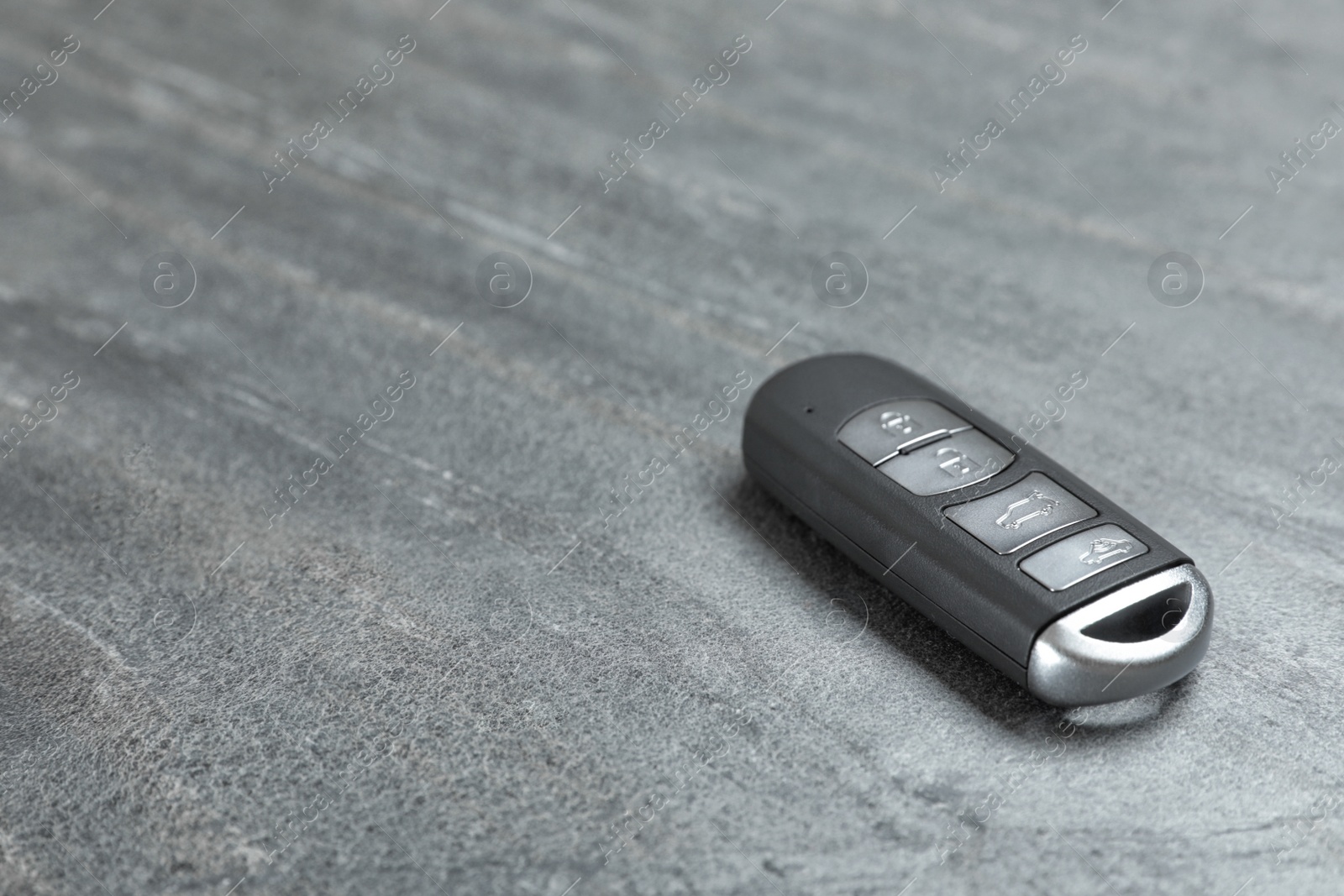 Photo of Car smart key on grey background. Space for text