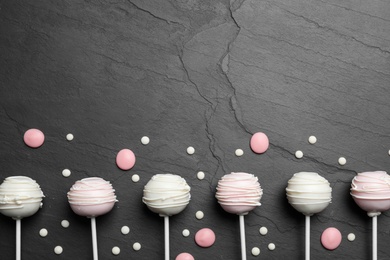 Photo of Flat lay composition with sweet cake pops on black background. Space for text