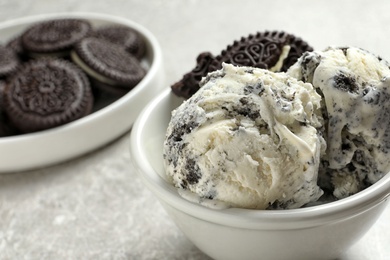 Photo of Bowl of chocolate cookies ice cream on table, closeup. Space for text