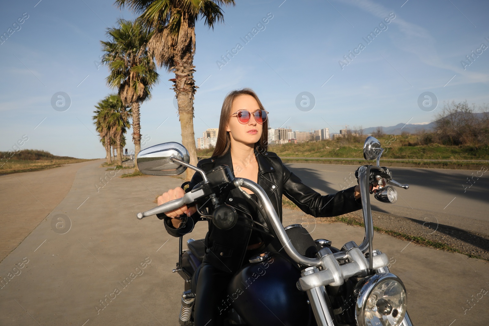 Photo of Beautiful woman riding motorcycle on sunny day