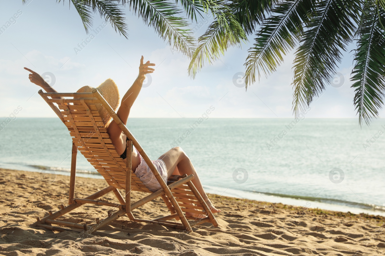 Image of Woman enjoying her summer vacation on sandy beach