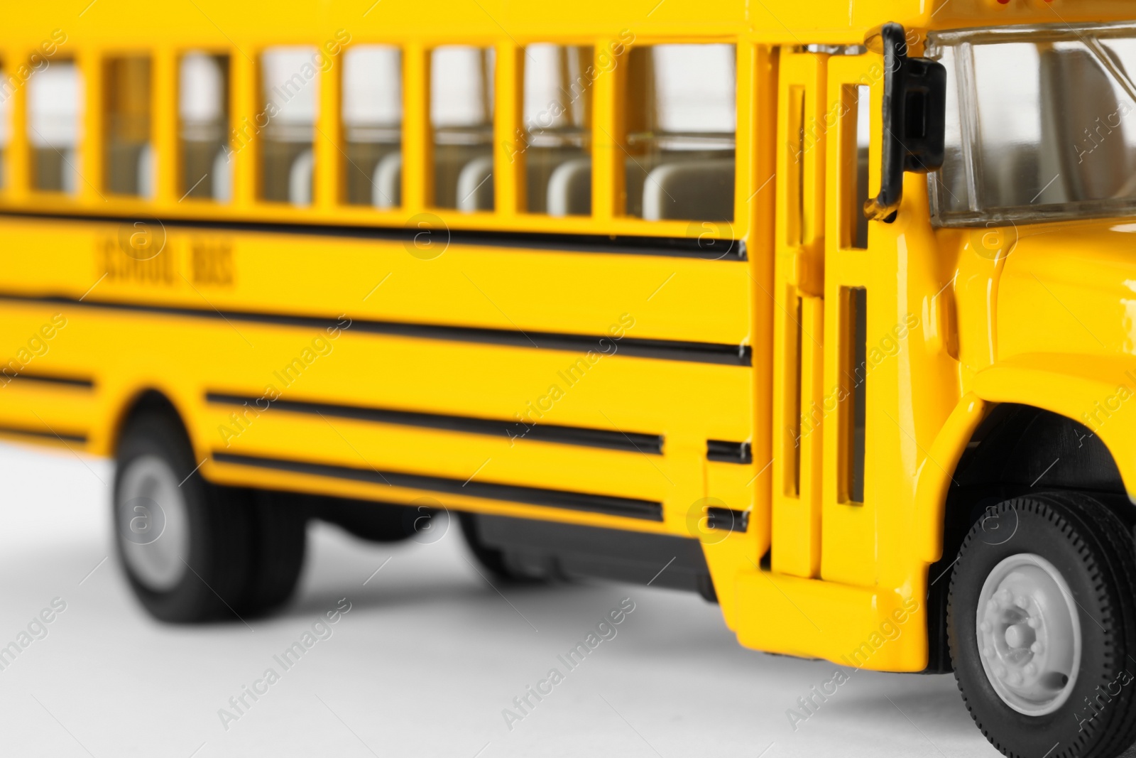 Photo of Yellow school bus on white background, closeup. Transport for students