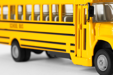 Photo of Yellow school bus on white background, closeup. Transport for students