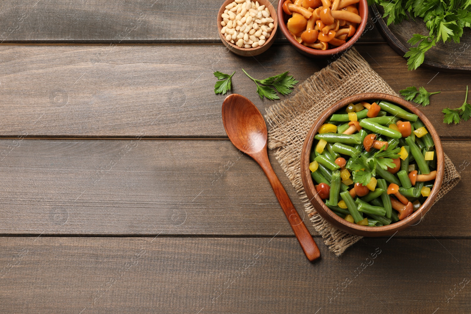 Photo of Tasty salad with green beans served on wooden table, flat lay. Space for text