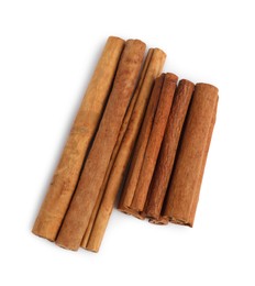 Photo of Dry aromatic cinnamon sticks isolated on white, top view