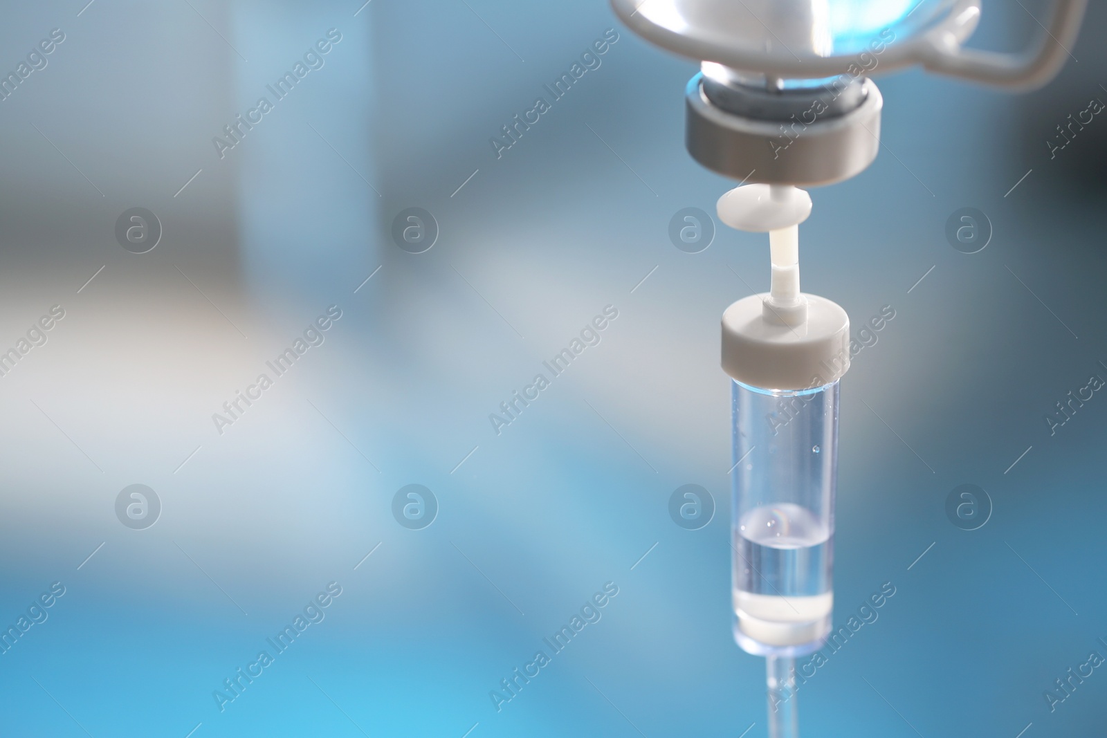 Photo of IV drip against blurred background, space for text