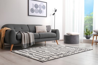 Photo of Living room interior with comfortable sofa and stylish rug