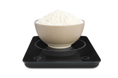 Photo of Modern kitchen scale with bowl of flour isolated on white