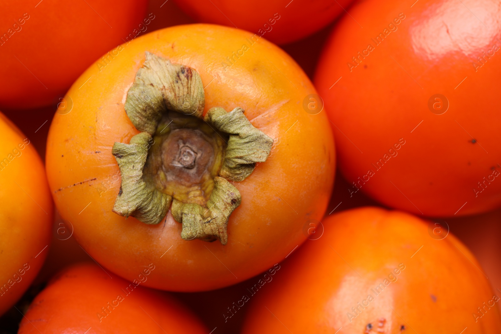 Photo of Delicious ripe juicy persimmons as background, closeup