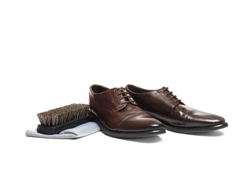 Stylish men's footwear and shoe care accessories on white background