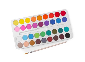 Photo of Watercolor palette and brush isolated on white, top view