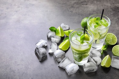 Photo of Refreshing beverage with mint and lime on table
