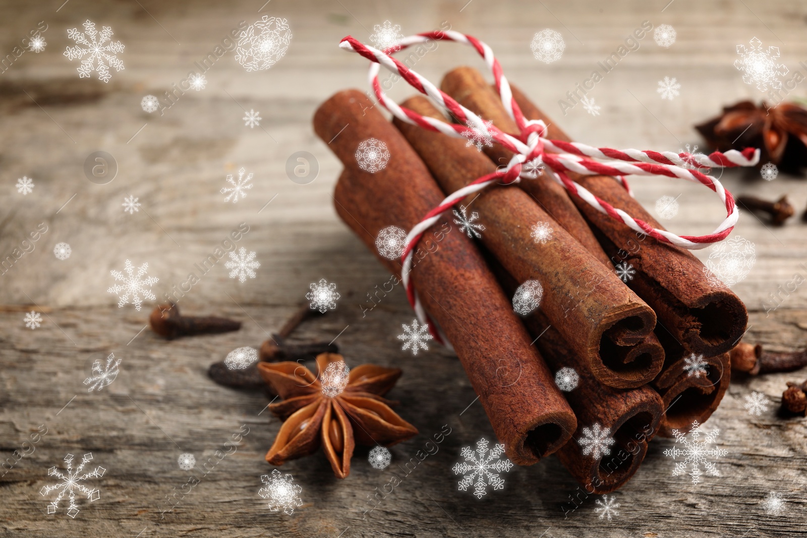 Image of Different spices on wooden table, closeup. Cinnamon, anise, cloves. Space for text