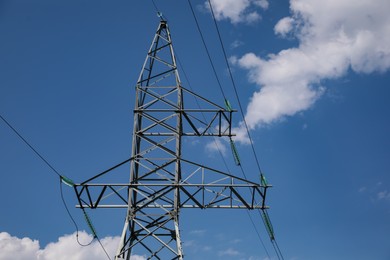 Photo of High voltage tower under blue cloudy sky