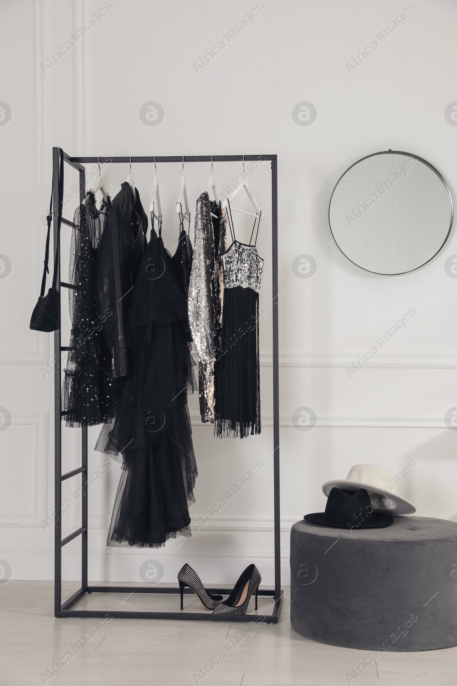 Photo of Stylish dressing room interior with trendy clothes, shoes and accessories