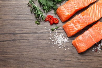 Fresh salmon and ingredients for marinade on wooden table, flat lay. Space for text