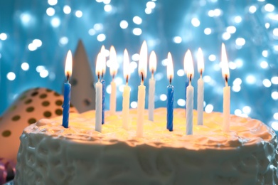 Delicious birthday cake with burning candles, closeup