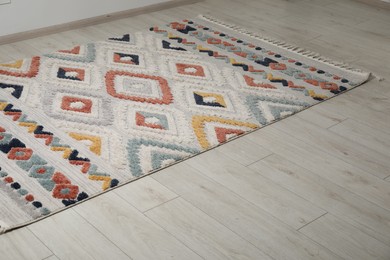 Photo of Soft carpet with pattern on white laminated floor indoors, space for text