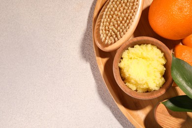 Photo of Natural body scrub, orange and brush on white table, top view with space for text. Anti cellulite treatment