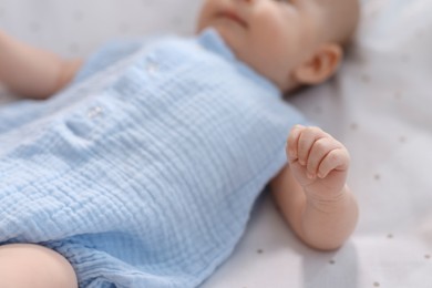 Cute little baby lying in crib at home, closeup