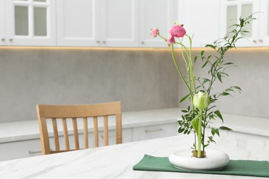 Photo of Ikebana art. Beautiful pink flowers and green branch carrying cozy atmosphere at home, space for text