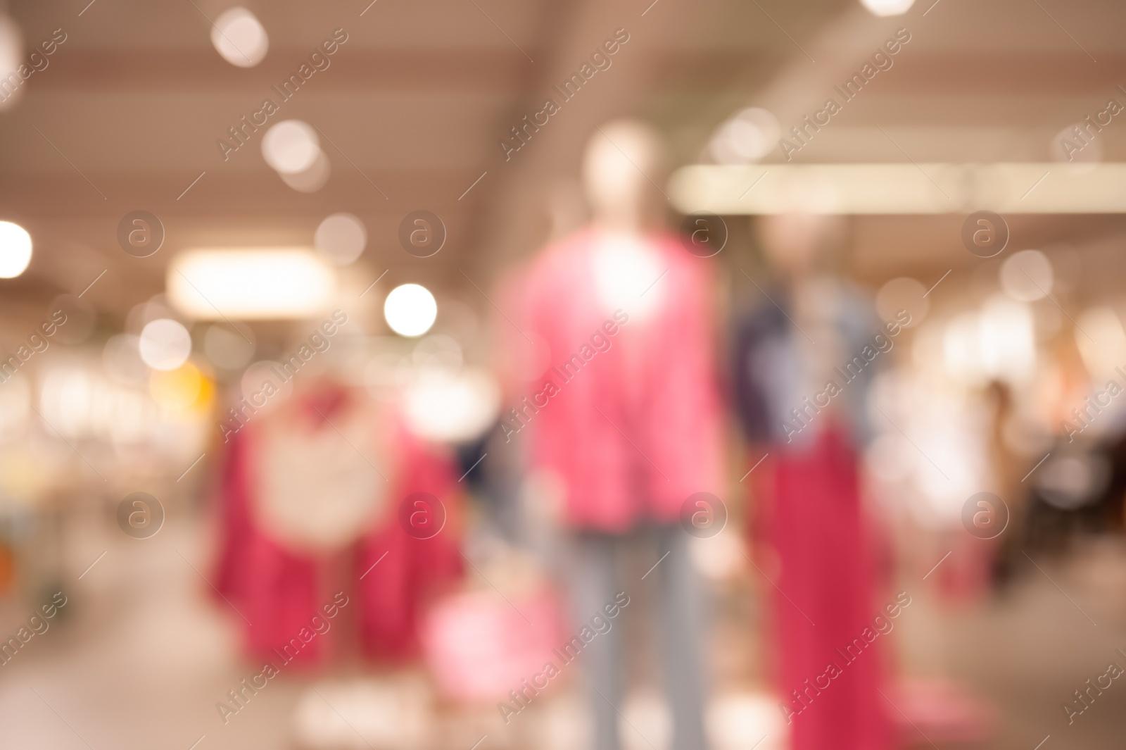 Photo of Blurred view of modern boutique interior with stylish clothes