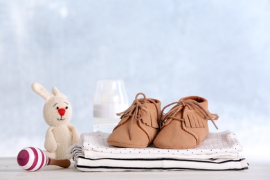 Photo of Set with baby accessories on table against light background