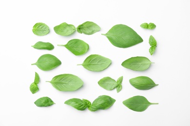 Photo of Fresh green basil leaves on white background, top view