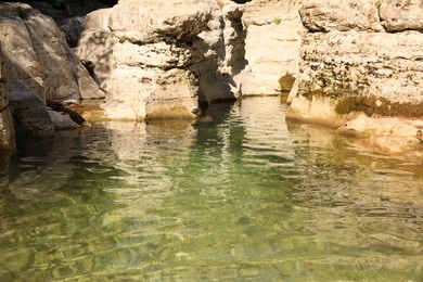 Photo of Beautiful clean pond and many rocks outdoors