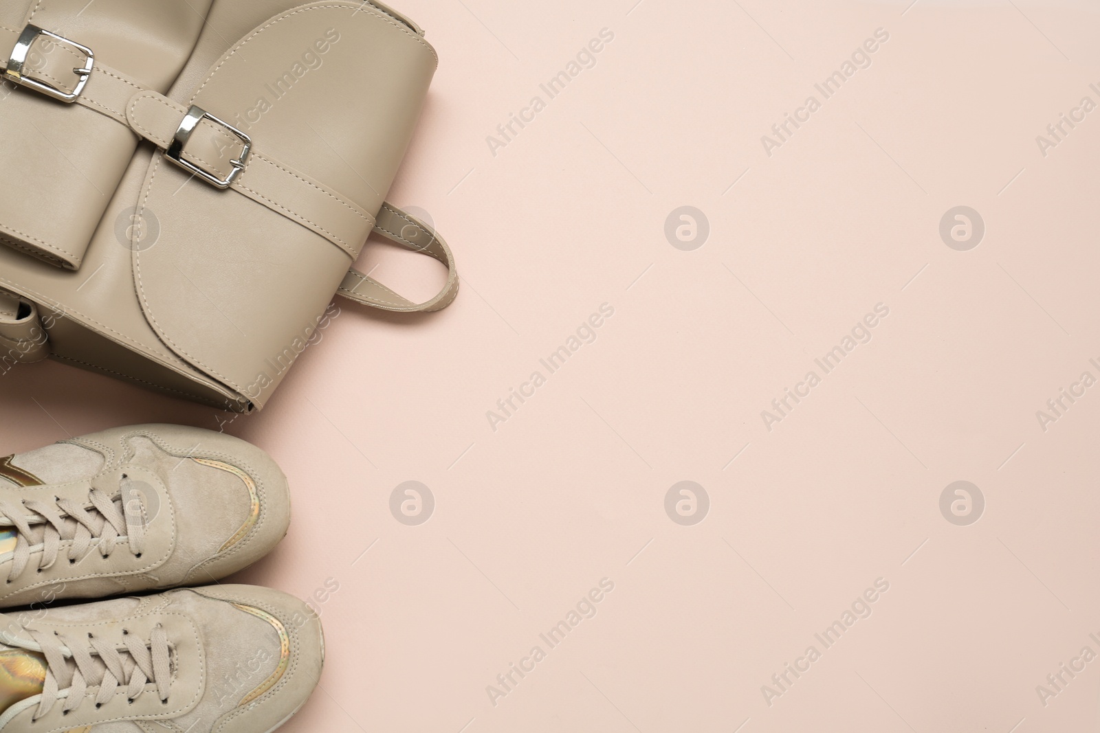 Photo of Backpack and sneakers on pink background, flat lay. Space for text