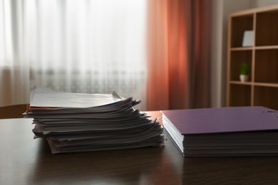 Photo of Stack of documents and office folder on wooden table in office